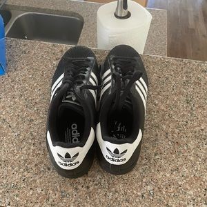 Men’s black and white Adidas Superstars size 9.5 never worn